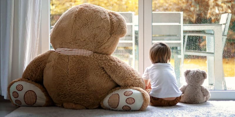 Preschooler playing with teddy bears on his own