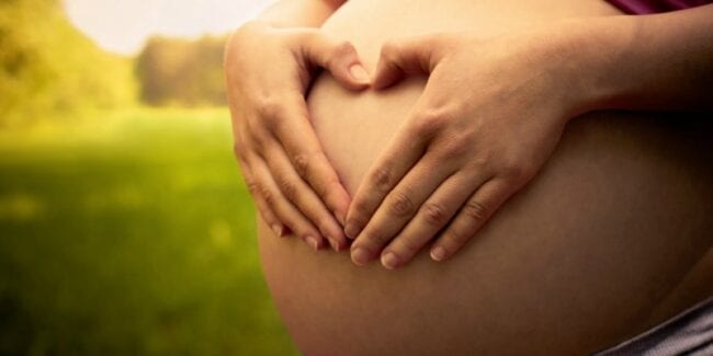 pregnant woman hands on, birth plan benefits