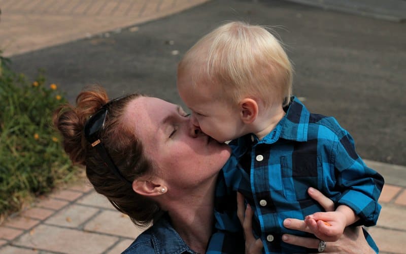 redhead mother hugging her toddler son showing her love for him