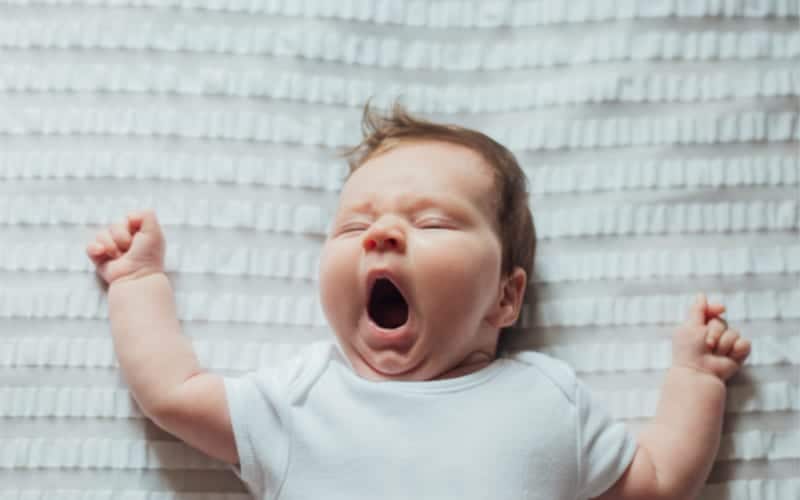 baby yawning sleepily