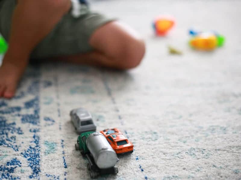 kid playing with toy cars